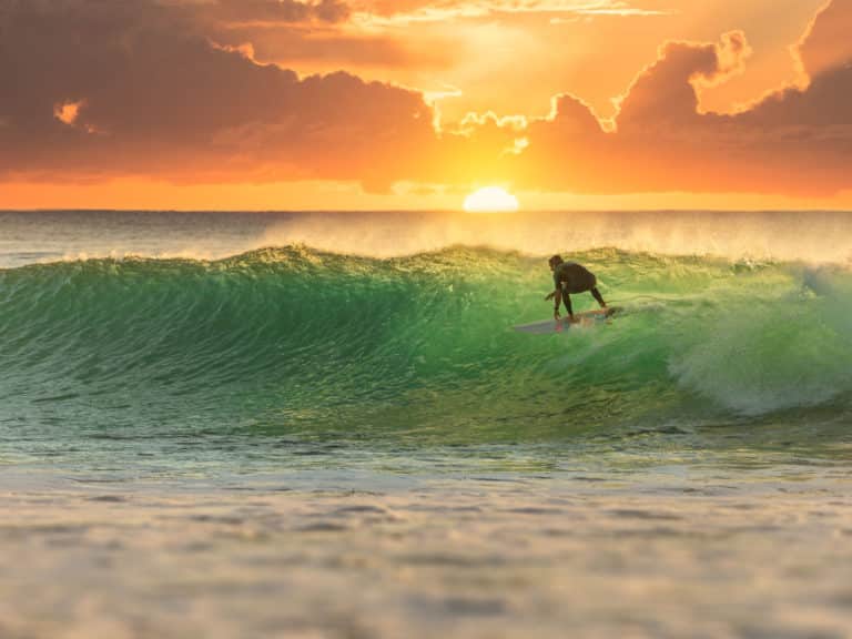 Person surfing. Becoming emotionally healthy.