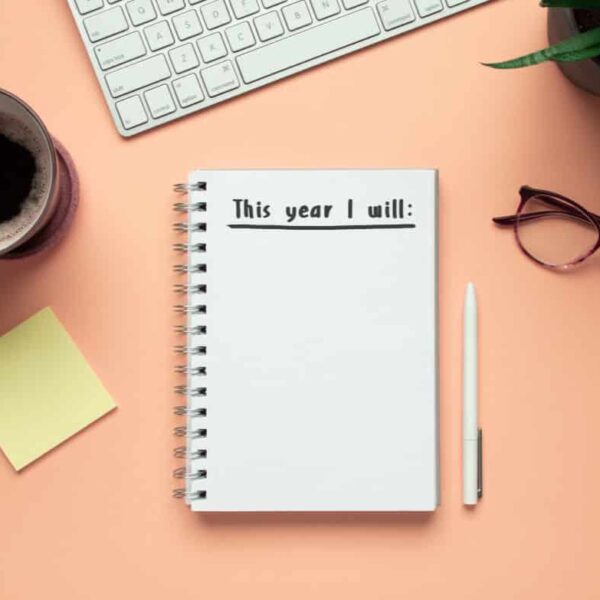 Notebook with new year's resolutions. How to Harness a Strengths-Based Approach to Reach Your Goals in the New Year.