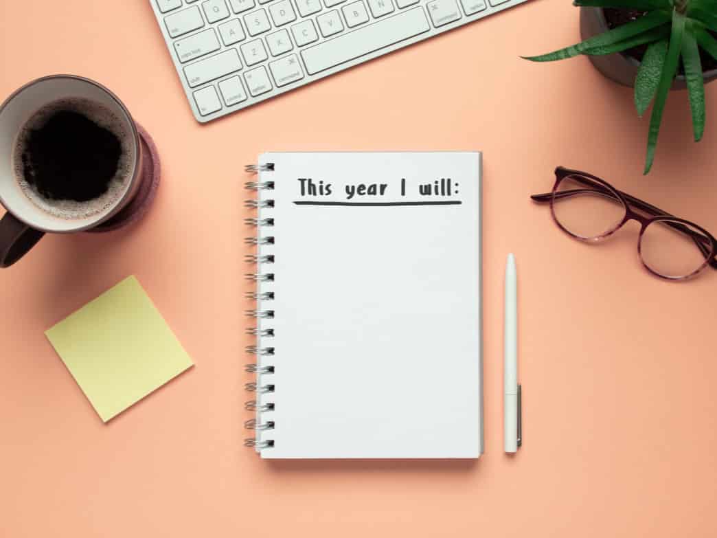 Notebook with new year's resolutions. How to Harness a Strengths-Based Approach to Reach Your Goals in the New Year.