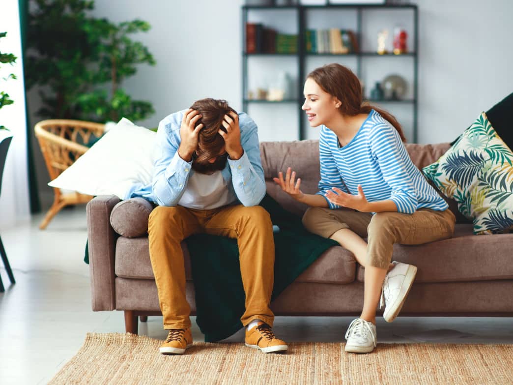 Couple talking on couch. what every couple should know about emotional flooding