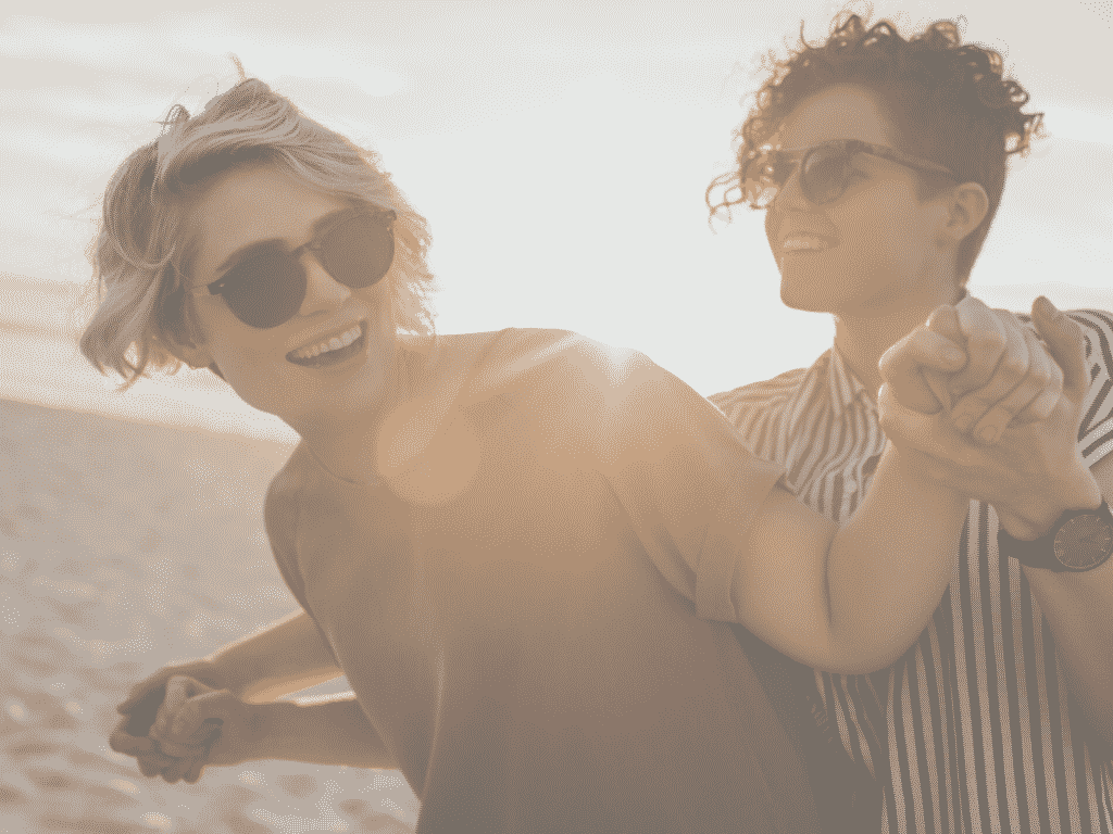 couple having fun at the beach representing what happy couples know.