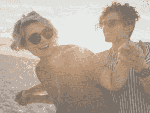 couple having fun at the beach representing what happy couples know.