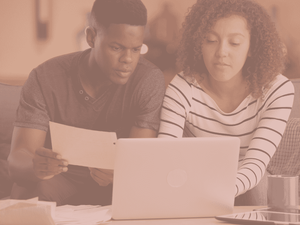 Couple looking at their finances representing: Should married couples merge finances?