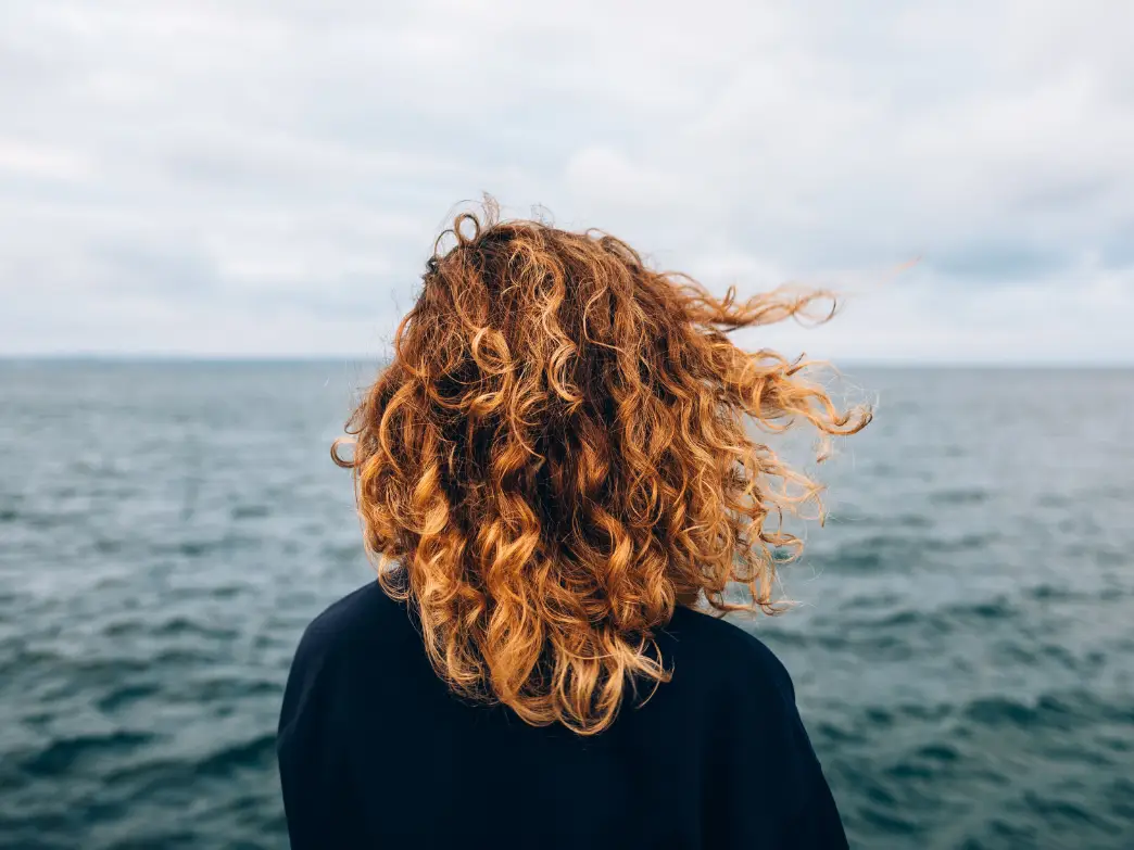 Woman looking out over the water. emotional self care when your life is falling apart.