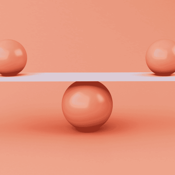 two smaller balls balancing on top of a bigger ball. finding balance.