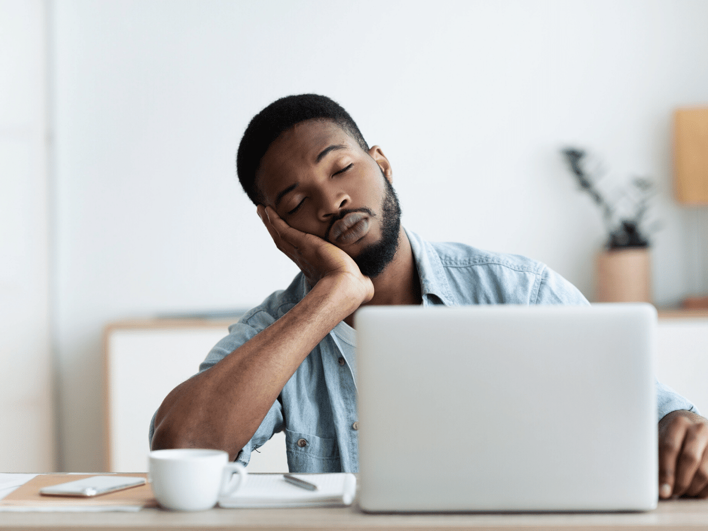 man at his laptop looking bored representing how boredom and space help you understand yourself