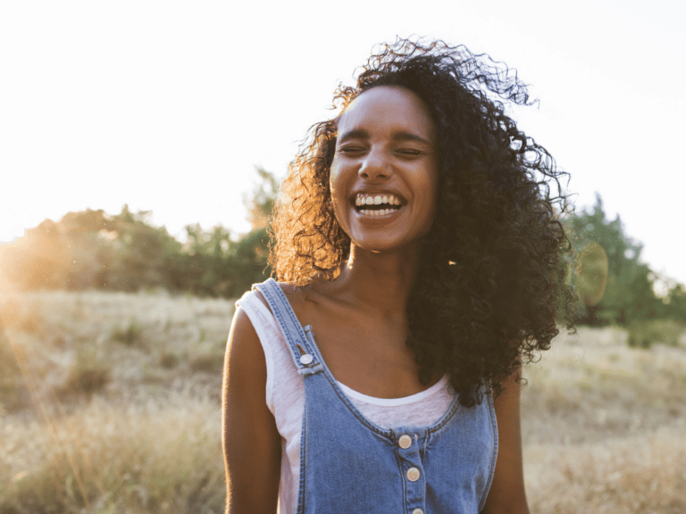 Happy and carefree woman representing Radical Acceptance: How to Cope in Uncertain Times