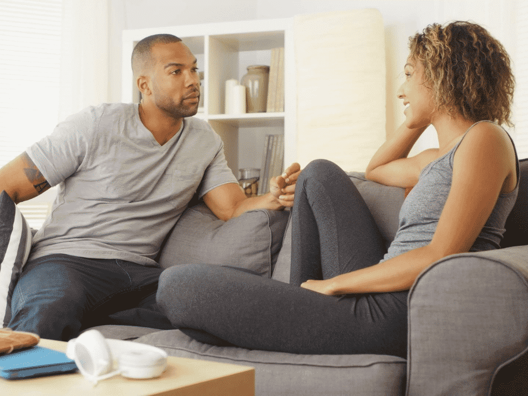 Couple talking on a couch representing Three tips for productive communication.