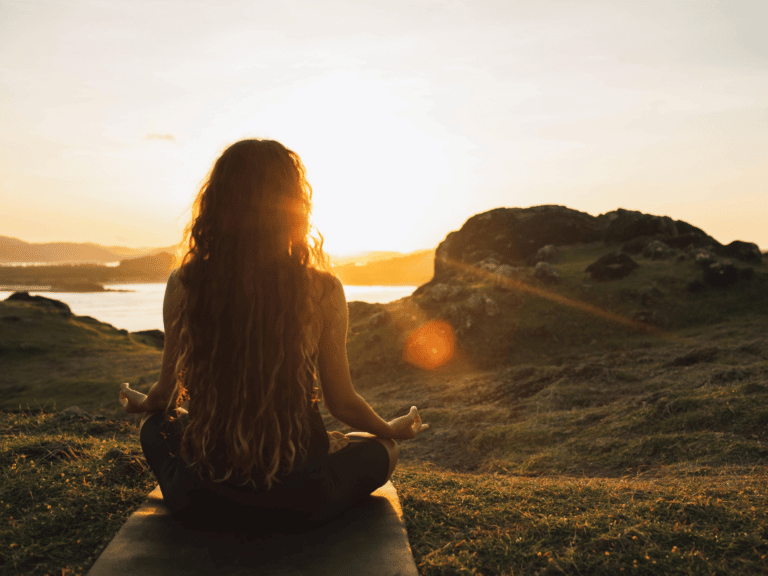woman meditating in front of the lake representing Healing Within after Tragedies in Lebanon