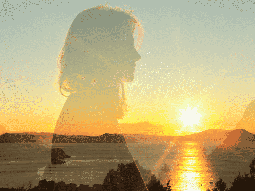 woman looking at sunset representing Personal Growth: The Greatest Gift