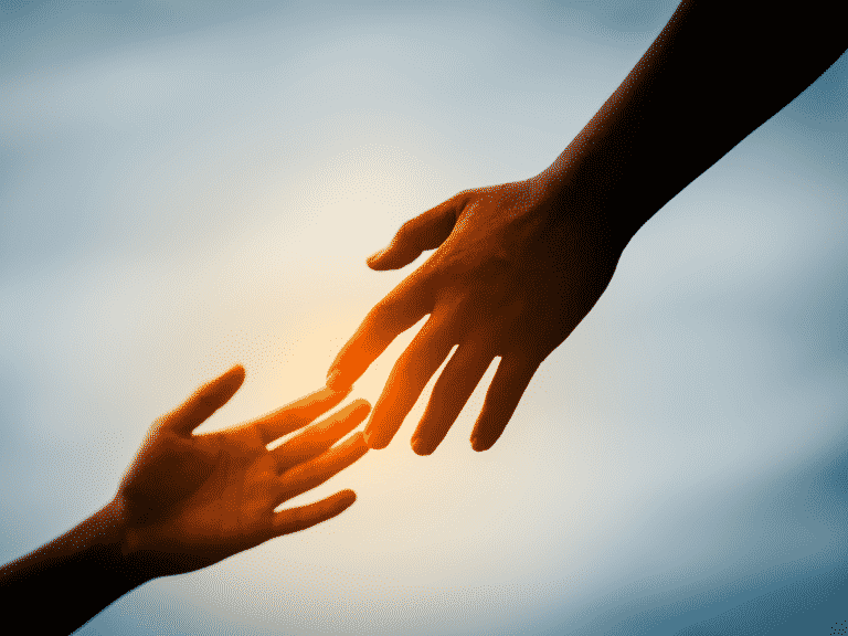 Two hands reaching out towards each other, fingertips touching representing Grow Together or Grow Apart
