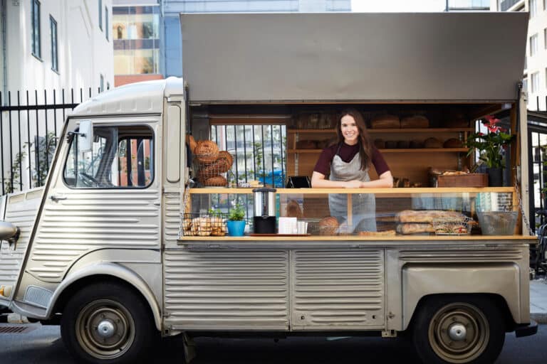 Woman smiling in food truck.