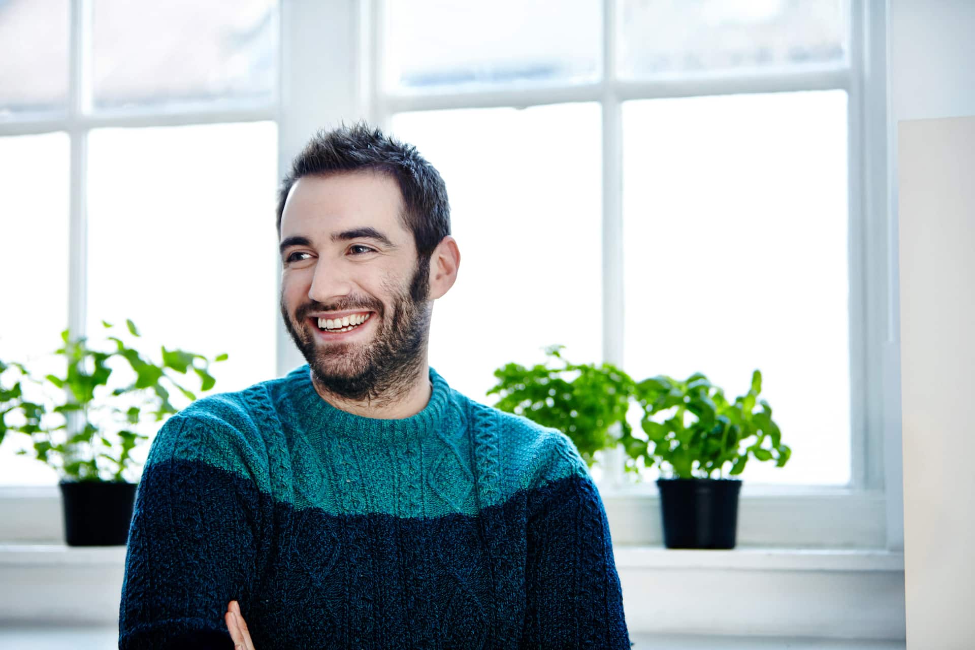 Photo of a happy man who just got hired after using professional resume writing services.