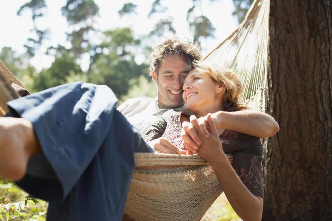 Couple sitting in a hammock representing affair counseling