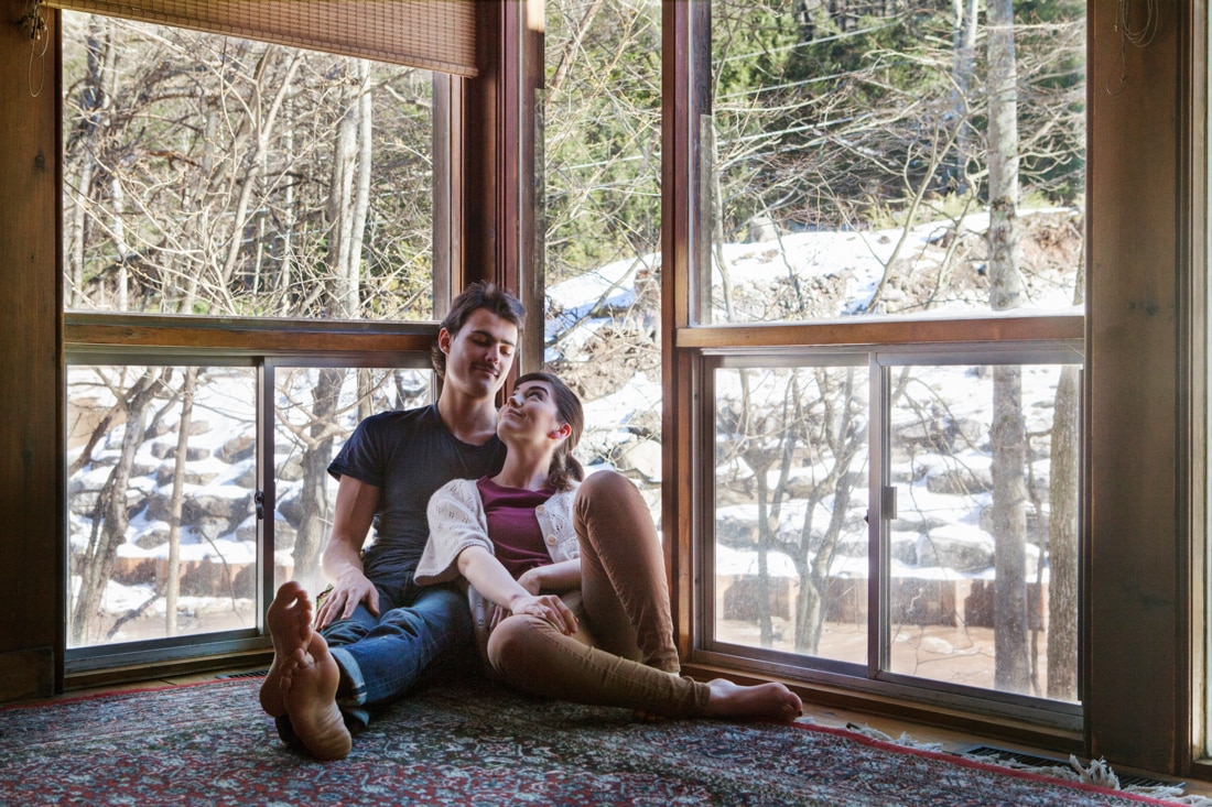 Couple sitting by window representing infertility challenges in building a family