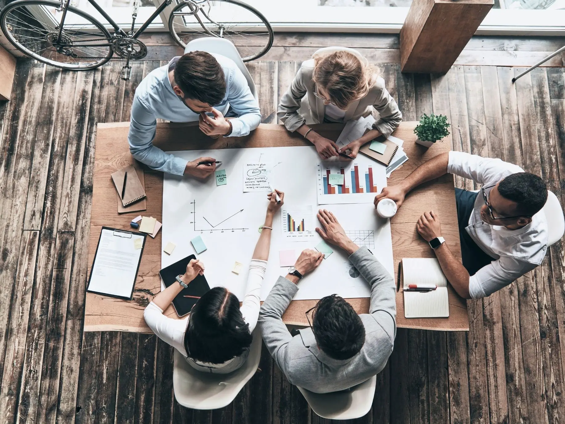 Coworkers working together around a table. Career Pathing representing How to Find Your Passion.