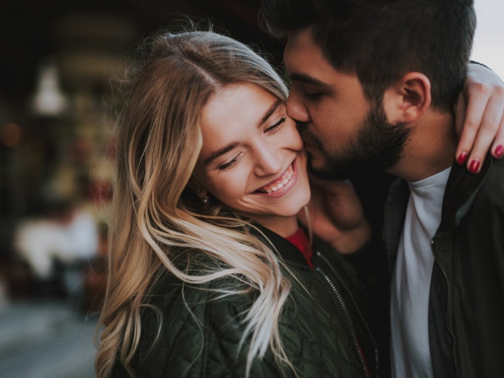 couple affectionately embracing one another. Keeping the romance alive.