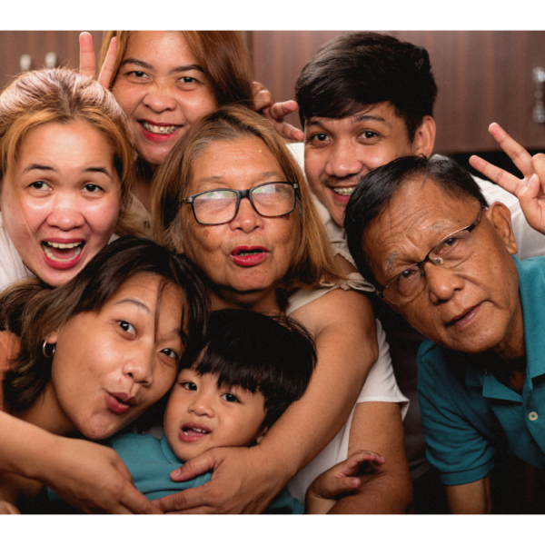 A big extended family smiles for the camera representing setting boundaries with parents