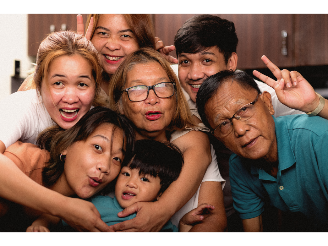 A big extended family smiles for the camera representing setting boundaries with parents