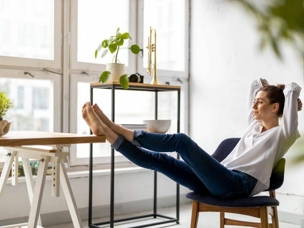 how to feel better about yourself, woman lounging confidently in chair looking out window.