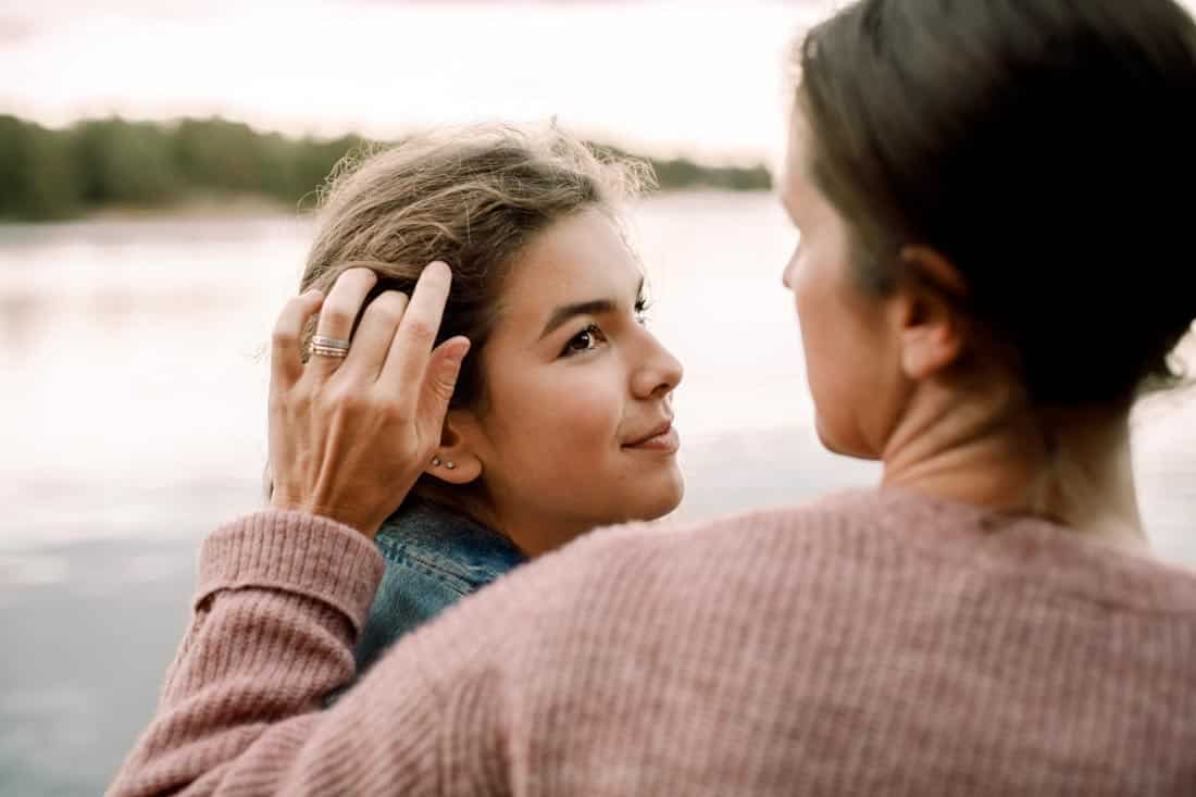 Mother touching daughter's hair, representing blended family counseling