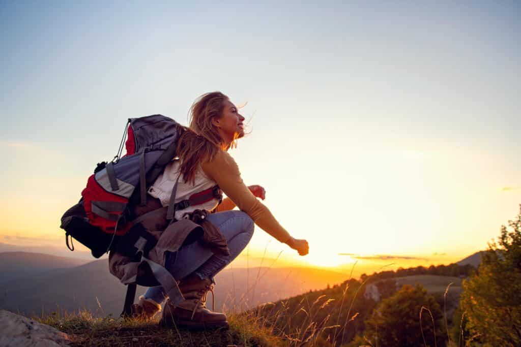 Hiking woman looking into sunset