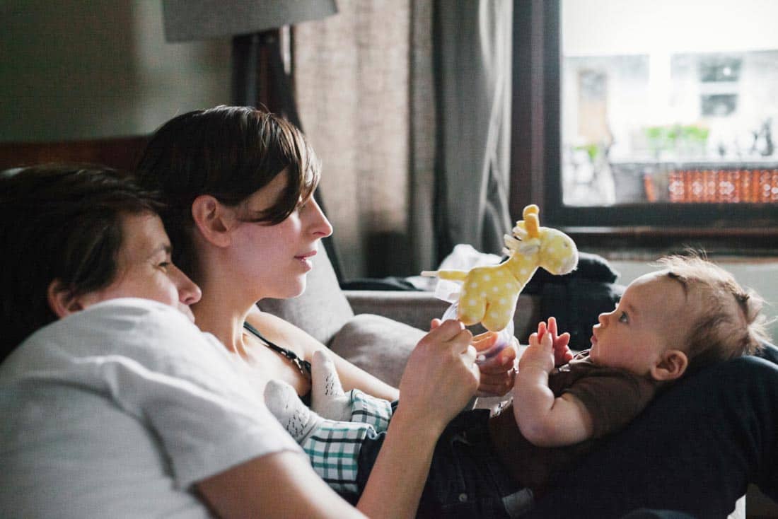 Couple playing with baby, representing Parenting Coaching and Family Therapy