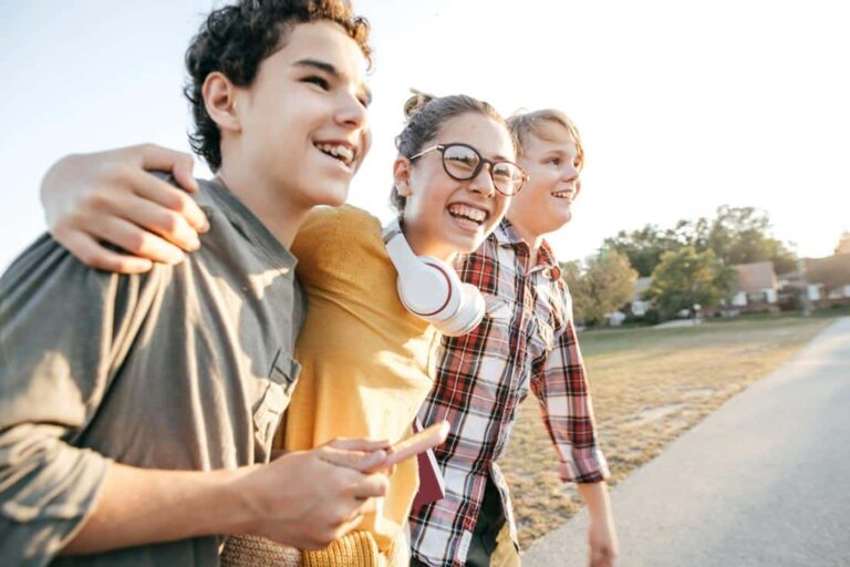 Pre-teens walking arm in arm