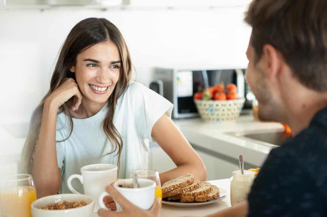 Couple eating breakfast together, representing visit after long distance couples therapy