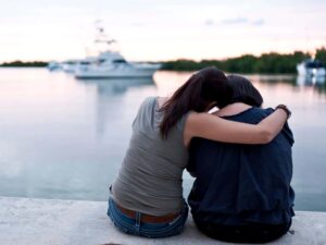 Woman embracing friend representing Healing Relationships