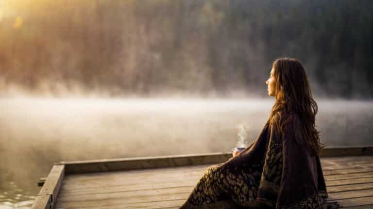 Woman sits quietly healing from heartbreak after divorce