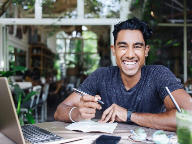 happy ethnic man rewriting his story and changing his life