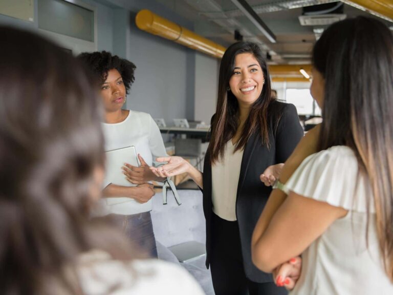 group of women talking, how to read people, communication skills