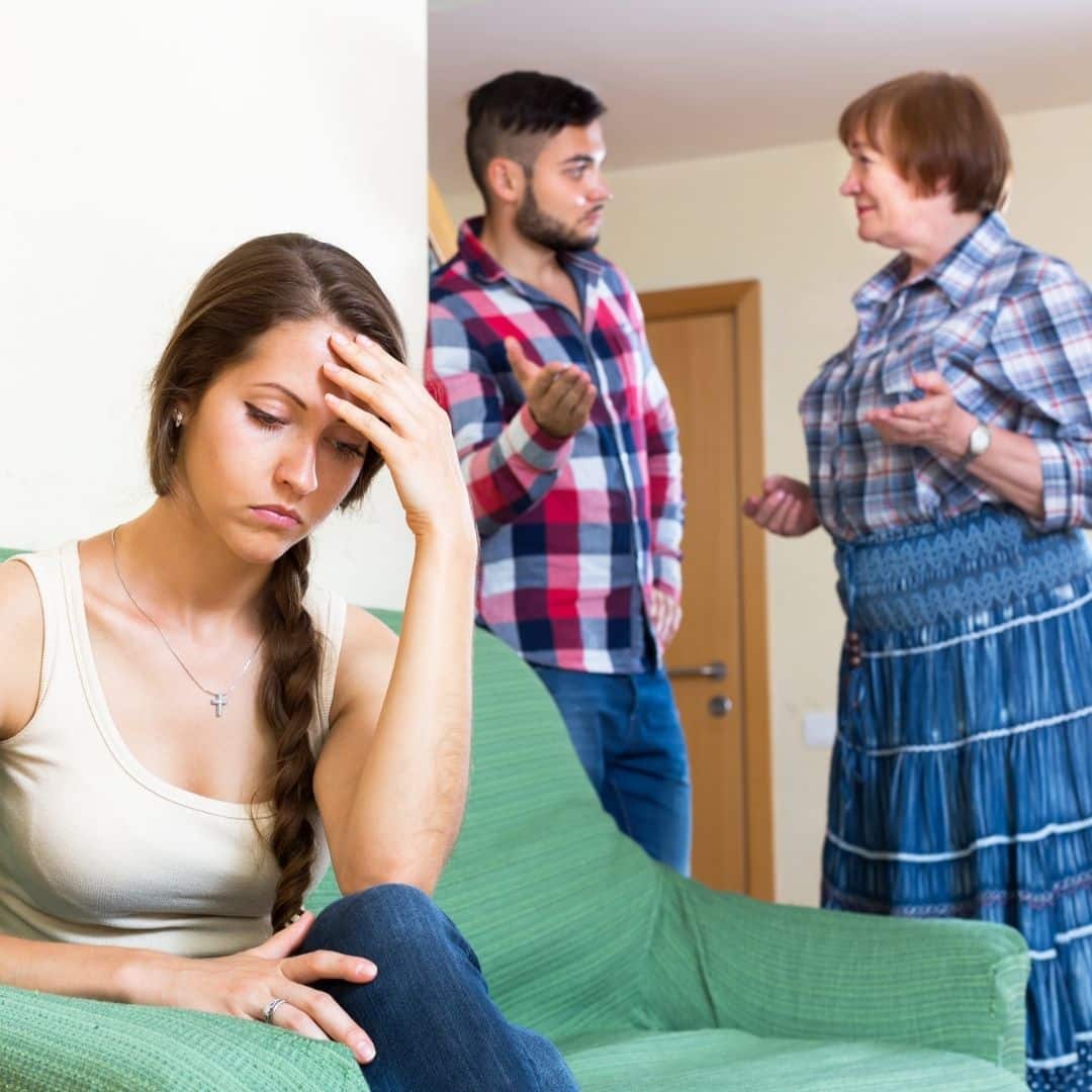 Woman distressed as boyfriend argues with her mom.