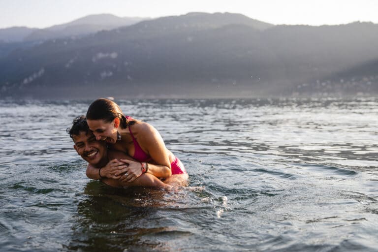 Couple on a date in the Denver mountains, swimming in a lake.