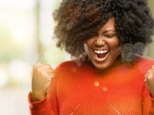 Believing in yourself: Woman feeling confident and excited about an accomplishment.