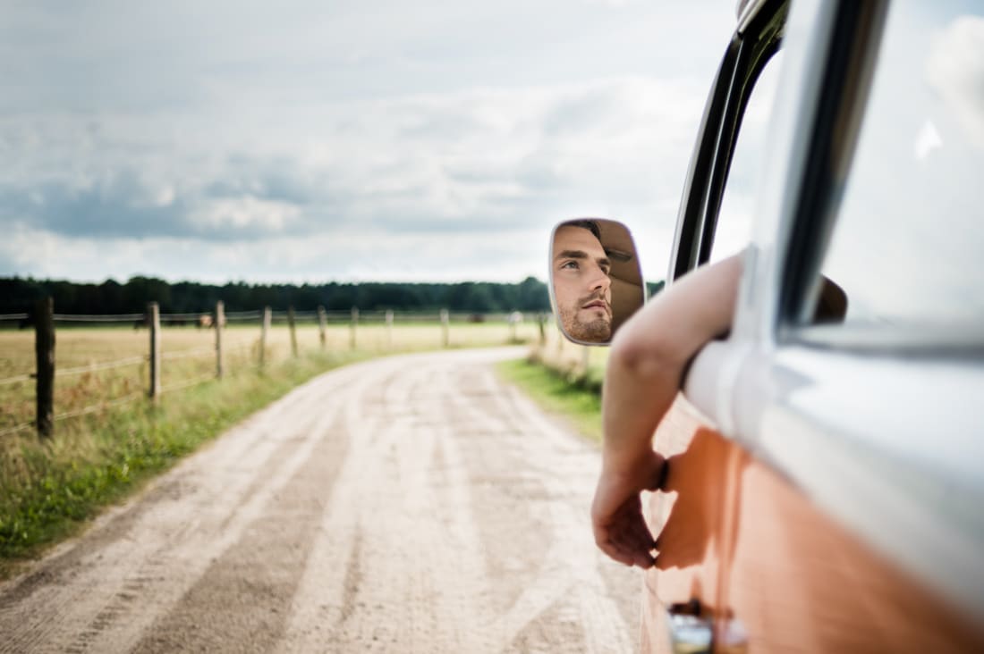 Man driving down Colorado road, representing Denver career counseling for empowered career choices