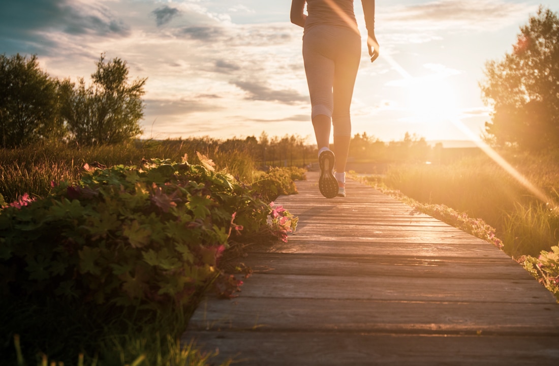 Woman jogging at sunset, representing divorce coaching