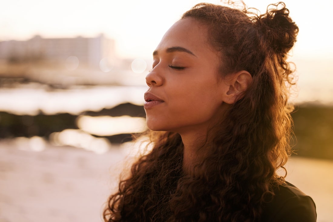 Young black woman practicing mindfulness after reading Exaholics book