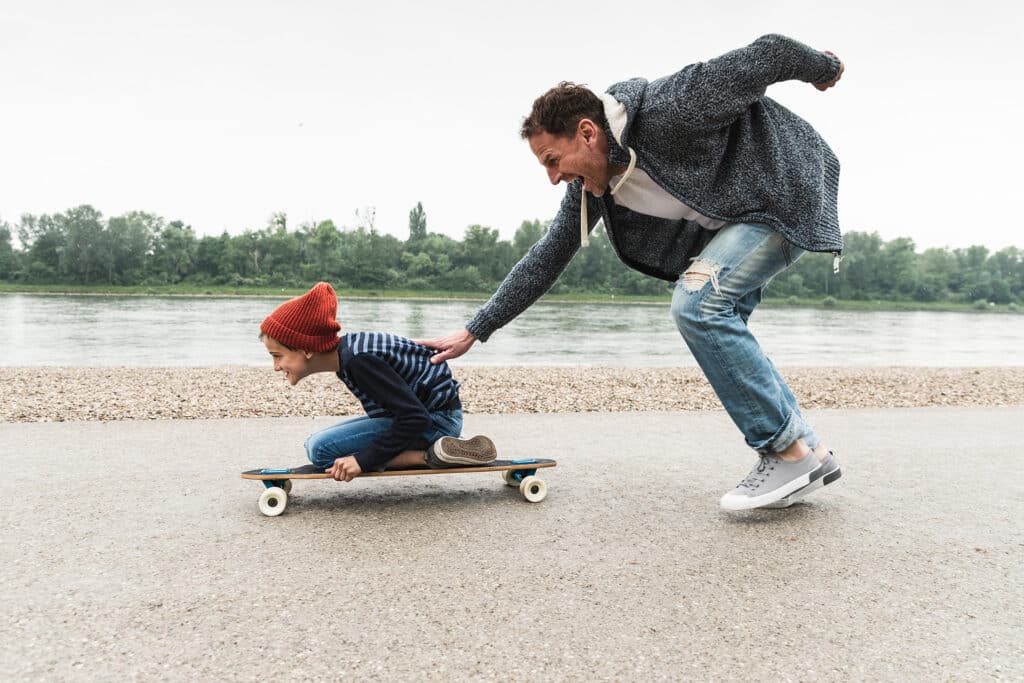 Photo of man playing with child representing relationship advice for happy families