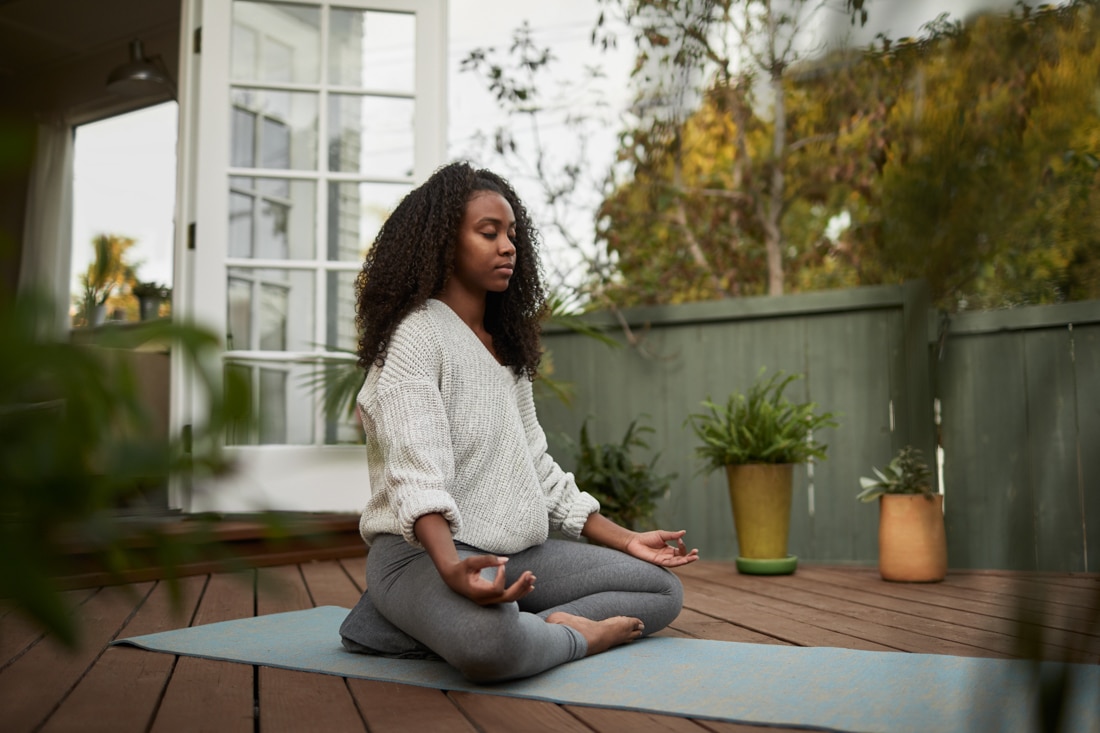 Young black woman doing yoga, representing breakup recovery and how to heal from heartbreak