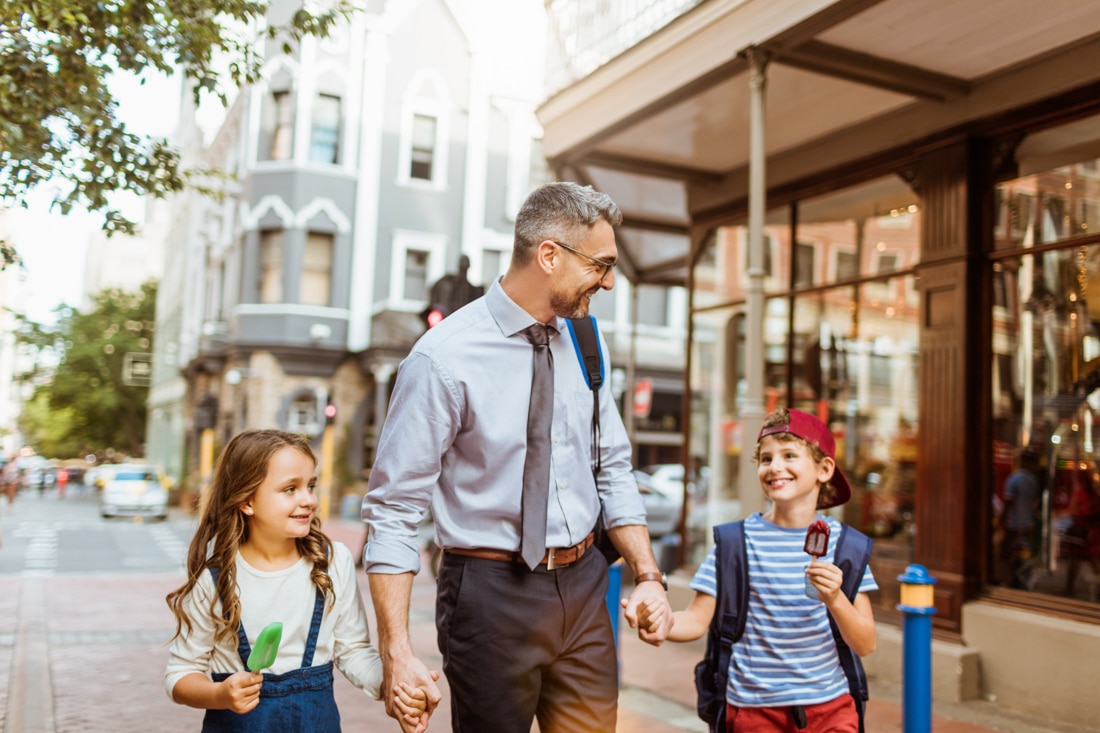 Father walking his kids home representing how to heal from heartbreak after divorce