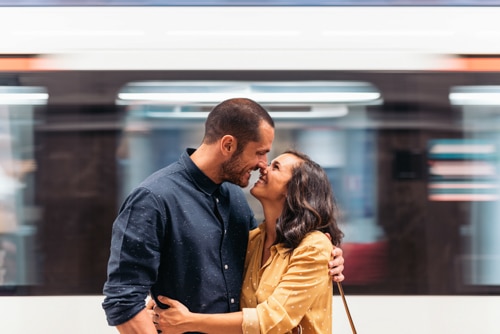 Photo of happy couple embracing in airport, representing Long Distance Relationship Advice