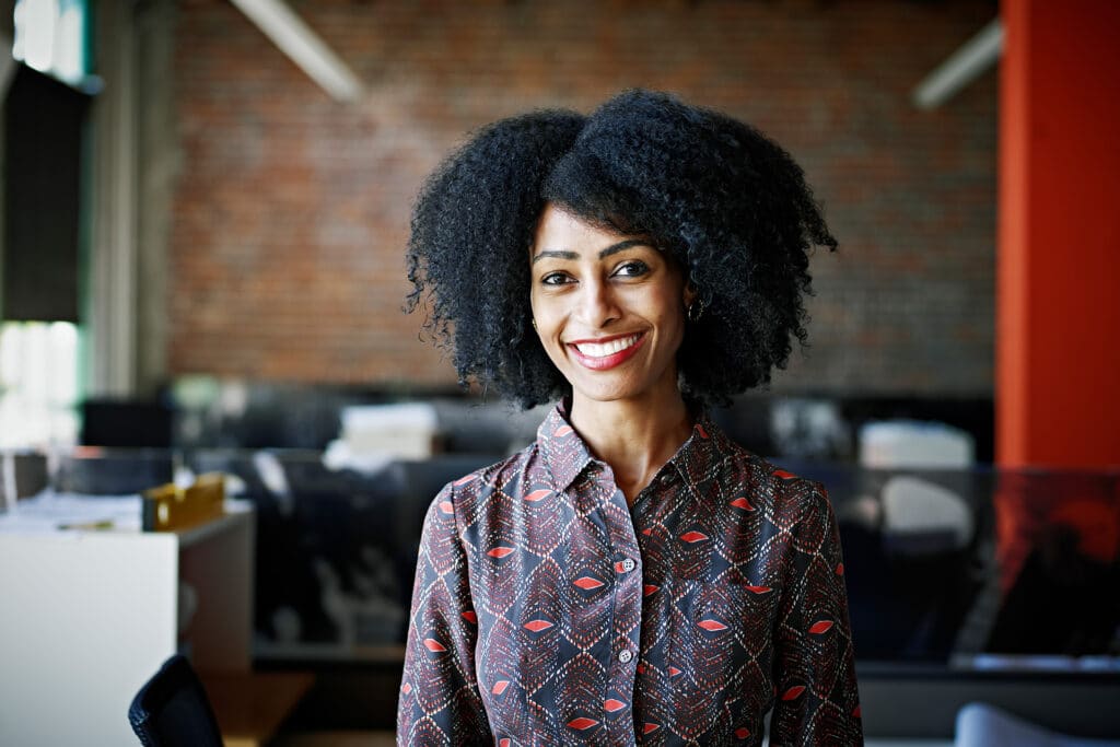 Photo of happy young woman in the office