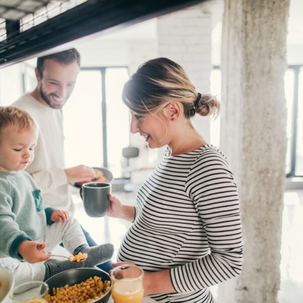 Photo of a young family preparing breakfast together in their kitchen