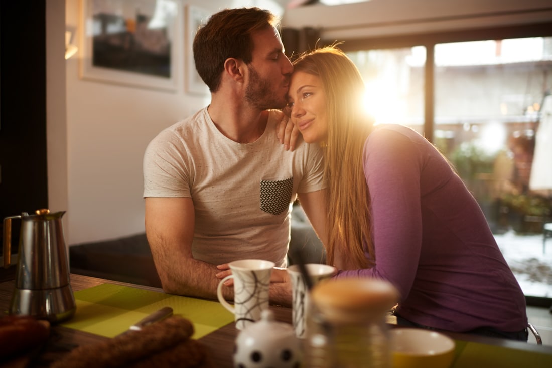 couple at breakfast being affectionate