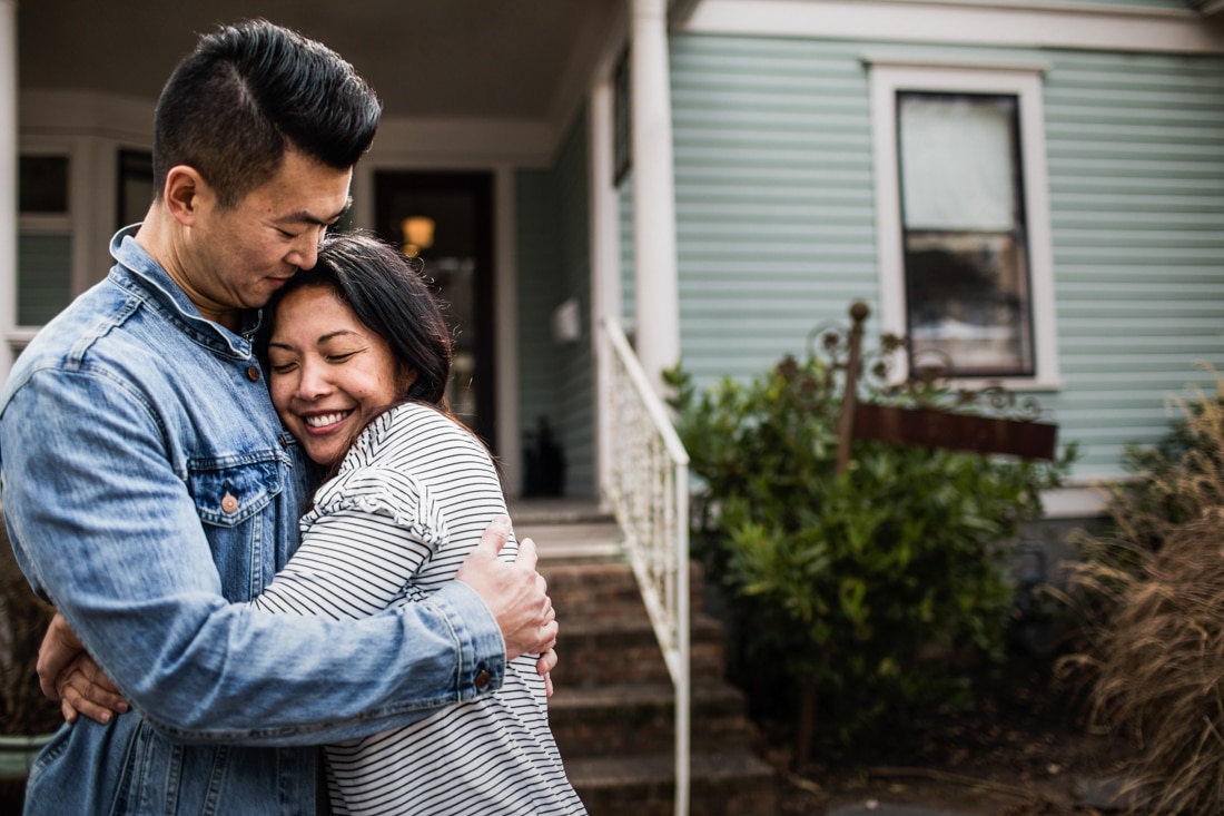 couple embracing in front of home, representing couples counseling and marriage counseling