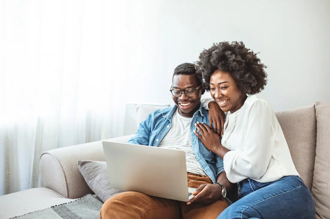 black couple using laptop for couples counseling online