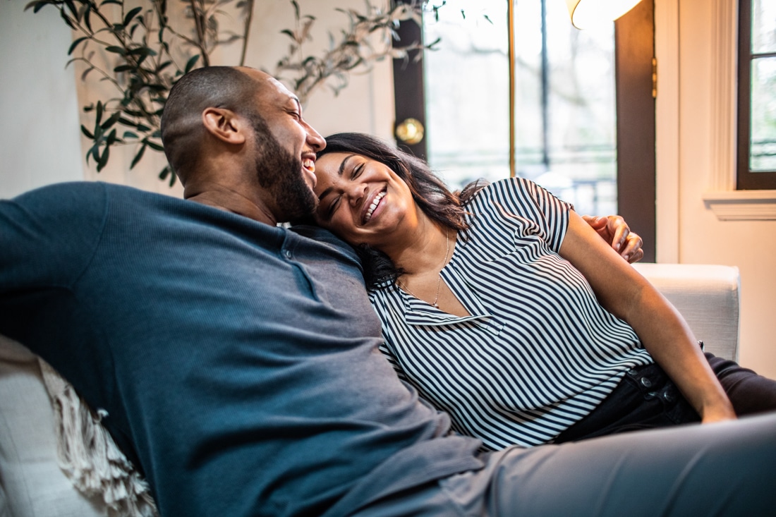 Married couple embracing on sofa