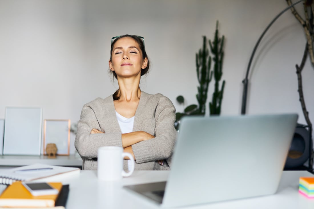 Denver Therapist: Young woman at home with laptop on desk having a break - overcome anxiety